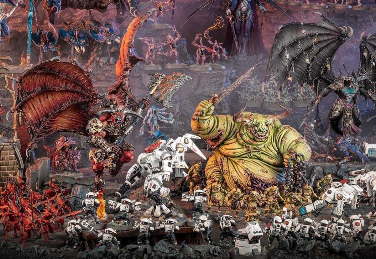 A battlefield of Chaos Daemons, including a giant bat-winged monster and a giant yellow-skinned monster.